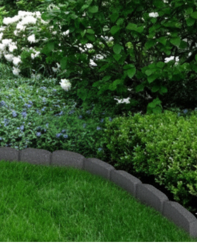 Nestled garden with a stone path winding through greenery and flowers